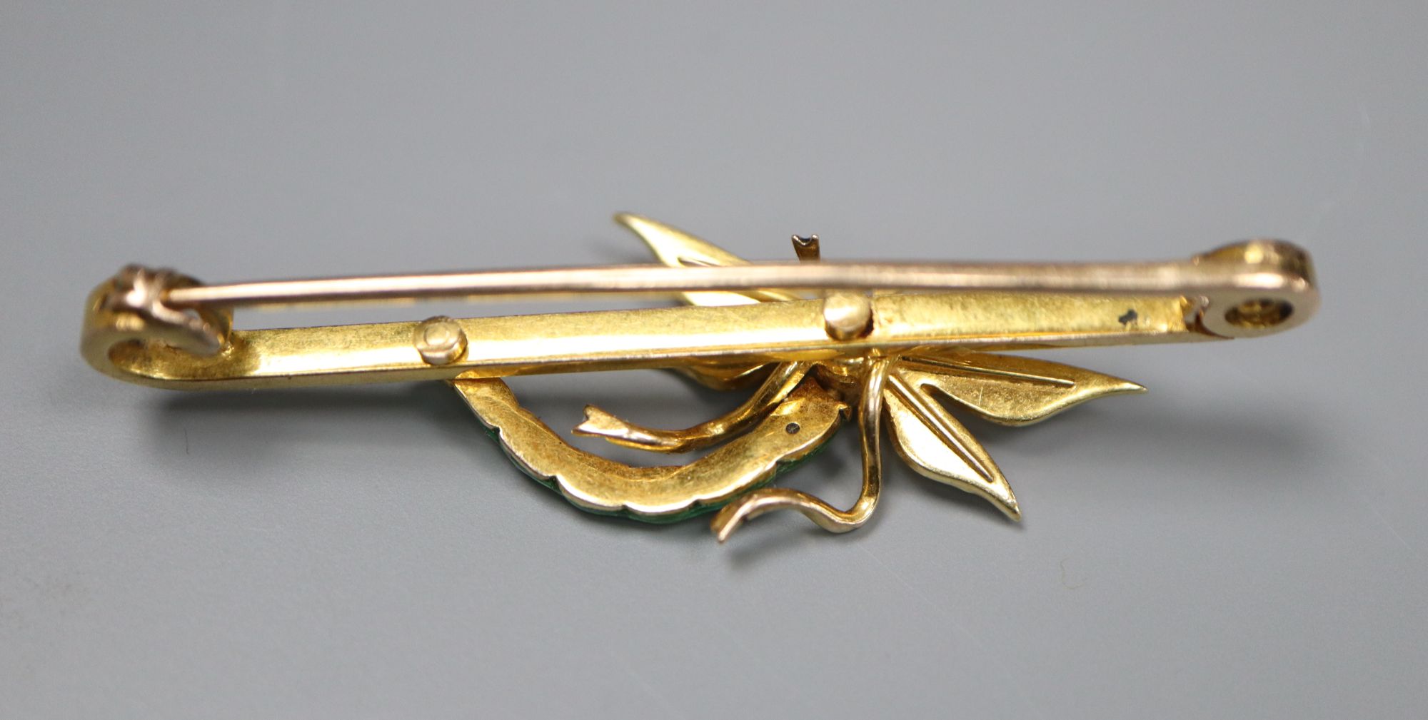 An Edwardian yellow metal, garnet?, seed pearl and green enamel set dragonfly bar brooch, 51mm, gross 6.7 grams.